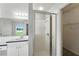 Bathroom featuring a glass enclosed shower and sink with vanity and backyard view at 1725 Bondurant Way, Brandon, FL 33511