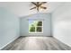 Bright bedroom with vaulted ceiling, ceiling fan, and a large window providing natural light at 1725 Bondurant Way, Brandon, FL 33511