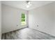 Bright bedroom with ceiling fan and window overlooking the landscaped yard at 1725 Bondurant Way, Brandon, FL 33511