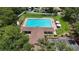 Aerial view of the community pool featuring a spacious pool, clubhouse, lounge chairs, and green space at 1725 Bondurant Way, Brandon, FL 33511