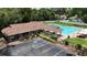 Aerial view of the community pool featuring a spacious pool, clubhouse, lounge chairs, and ample parking at 1725 Bondurant Way, Brandon, FL 33511