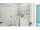 Bright laundry room with modern washer and dryer, and convenient shelving for storage at 1725 Bondurant Way, Brandon, FL 33511