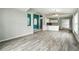 Open concept living space with stylish gray wood-look floors, a great space for entertaining at 1725 Bondurant Way, Brandon, FL 33511