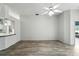 Open living room featuring stylish wood-look floors and a ceiling fan, with a view of the kitchen at 1725 Bondurant Way, Brandon, FL 33511