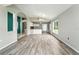 Open concept living space with stylish gray wood-look floors, a great space for entertaining at 1725 Bondurant Way, Brandon, FL 33511