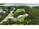 Aerial view of the community park featuring a large field, playground, and natural surroundings near a lake at 1725 Bondurant Way, Brandon, FL 33511
