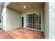 Covered patio featuring beautiful tile flooring and sliding glass doors, perfect for outdoor relaxation at 1725 Bondurant Way, Brandon, FL 33511