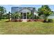 View of the screened in lanai with lush green grass and greenery at 1725 Bondurant Way, Brandon, FL 33511