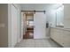Chic bathroom with white cabinets, marble counters, a sliding door, and stylish design elements at 17544 Fairmeadow Dr, Tampa, FL 33647