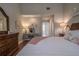 Comfortable bedroom with a vanity, neutral walls, and plush bedding for a relaxing retreat at 17544 Fairmeadow Dr, Tampa, FL 33647