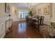 Charming dining room featuring hardwood floors, a classic chandelier, and large window with shutter detail at 17544 Fairmeadow Dr, Tampa, FL 33647
