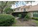 Back exterior view of home with screened in porch surrounded by foliage at 17544 Fairmeadow Dr, Tampa, FL 33647