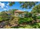 View of a covered gazebo and pool with manicured landscaping and lush foliage under a clear blue sky at 17544 Fairmeadow Dr, Tampa, FL 33647