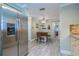 Kitchen boasts stainless steel refrigerator along with center island with seating, and access to other rooms at 17544 Fairmeadow Dr, Tampa, FL 33647