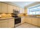 Cozy kitchen with granite countertops, stainless steel appliances, and a bright window over the sink at 17544 Fairmeadow Dr, Tampa, FL 33647