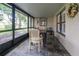 Cozy screened patio with dining set, offering a relaxing outdoor space at 17544 Fairmeadow Dr, Tampa, FL 33647