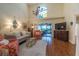 Open living room showcases a vaulted ceiling, neutral decor, and sliding glass doors to the outdoor patio at 17544 Fairmeadow Dr, Tampa, FL 33647