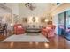 Inviting living room featuring hardwood floors, a vaulted ceiling, chandelier, and plenty of natural light at 17544 Fairmeadow Dr, Tampa, FL 33647
