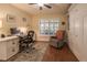 Comfortable home office with built-in storage, natural light, and a cozy reading chair for relaxation at 17544 Fairmeadow Dr, Tampa, FL 33647