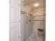 Accessible walk-in shower featuring safety bars, a shower seat, and stylish tile accents at 17544 Fairmeadow Dr, Tampa, FL 33647