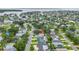 An aerial view shows a house near a body of water, surrounded by trees and other homes in a neighborhood at 1878 New Hampshire Ne Ave, St Petersburg, FL 33703