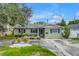 Charming single-story home with a cozy front porch and a well-manicured front yard, set under a sunny blue sky at 1878 New Hampshire Ne Ave, St Petersburg, FL 33703