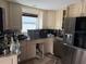 A kitchen in need of repairs, featuring cabinetry, stainless steel appliances, and a window for natural lighting at 1878 New Hampshire Ne Ave, St Petersburg, FL 33703