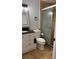 Well-lit bathroom with modern vanity, framed mirror, and a glass-enclosed shower at 1900 W Kirby St, Tampa, FL 33604