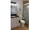 Well-lit bathroom with modern vanity, framed mirror, and a glass-enclosed shower at 1900 W Kirby St, Tampa, FL 33604
