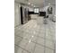 Modern kitchen with white cabinets, stainless steel appliances, and an island with bar seating at 1900 W Kirby St, Tampa, FL 33604