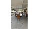 Enclosed patio featuring dining area, laundry machines and plenty of space for relaxing and entertaining at 1900 W Kirby St, Tampa, FL 33604
