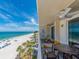 Relax on this condo's balcony with stunning beach views, patio furniture, and a ceiling fan at 20002 Gulf Blvd # 2803, Indian Shores, FL 33785