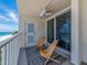 Balcony overlooking a beautiful beach with two lounge chairs; relax and enjoy the scenic view at 20002 Gulf Blvd # 2803, Indian Shores, FL 33785