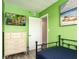 Bright bedroom featuring a television, door to hall, chest of drawers, and decor at 20002 Gulf Blvd # 2803, Indian Shores, FL 33785