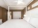 Bright bedroom featuring a four-poster bed, with white linens, and neutral decor at 20002 Gulf Blvd # 2803, Indian Shores, FL 33785