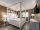 Beautifully staged bedroom features a four-poster bed, neutral decor, and great natural light at 20002 Gulf Blvd # 2803, Indian Shores, FL 33785