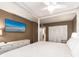 A beautifully designed bedroom features a large TV, white furnishings, and ample closet space at 20002 Gulf Blvd # 2803, Indian Shores, FL 33785