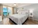 Bedroom with a large bed, ceiling fan, and sliding glass doors to a private balcony with ocean views at 20002 Gulf Blvd # 2803, Indian Shores, FL 33785