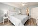 Comfortable bedroom featuring light blue walls, a decorative headboard, and an ensuite bathroom at 20002 Gulf Blvd # 2803, Indian Shores, FL 33785