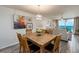Bright dining room with wood table, seating for six, ocean views, and decorative chandelier at 20002 Gulf Blvd # 2803, Indian Shores, FL 33785
