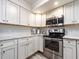 Close up of modern kitchen with stainless steel appliances and white cabinets with modern hardware at 20002 Gulf Blvd # 2803, Indian Shores, FL 33785