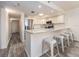 Bright kitchen features white cabinets, stainless steel appliances, and a breakfast bar with seating at 20002 Gulf Blvd # 2803, Indian Shores, FL 33785