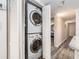In-unit laundry with stacked washer and dryer, tucked away behind folding doors at 20002 Gulf Blvd # 2803, Indian Shores, FL 33785