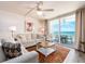 The living room is filled with natural light and offers access to the balcony with gorgeous ocean views at 20002 Gulf Blvd # 2803, Indian Shores, FL 33785