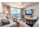 The light and airy living room offers a cozy seating area and access to a private balcony with ocean views at 20002 Gulf Blvd # 2803, Indian Shores, FL 33785