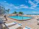 Inviting community swimming pool with surrounding lounge chairs for relaxation at 20002 Gulf Blvd # 2803, Indian Shores, FL 33785