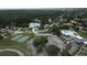 An aerial view showcases a community with a basketball court, pool, and scenic lake at 23220 Shining Star Dr, Land O Lakes, FL 34639