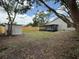 Backyard with sunroom, privacy fence and storage shed at 23220 Shining Star Dr, Land O Lakes, FL 34639