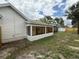 Spacious backyard with attached sunroom featuring large windows and screened-in porch at 23220 Shining Star Dr, Land O Lakes, FL 34639