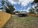 Fenced backyard with sunroom and mature trees, offering privacy at 23220 Shining Star Dr, Land O Lakes, FL 34639